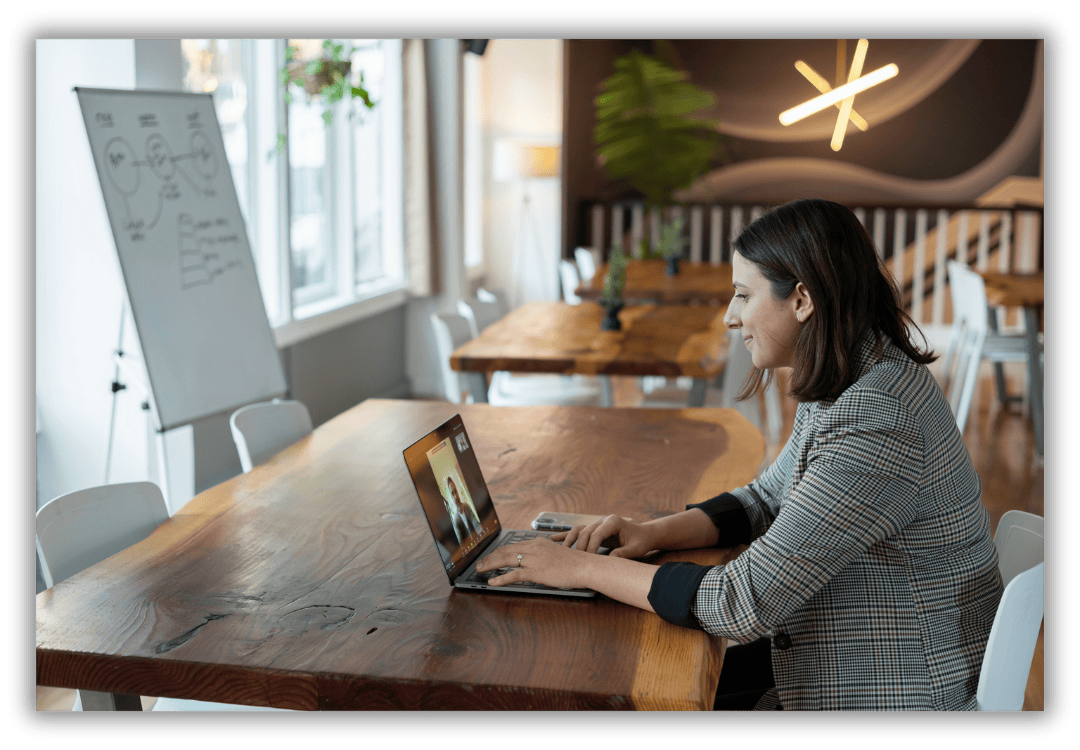 Individual meeting someone virtually on a laptop 