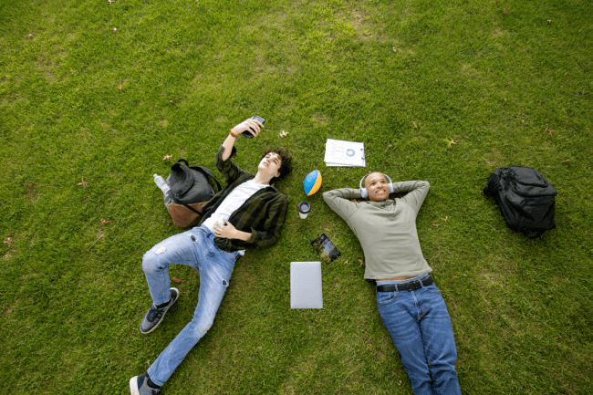 Two people laying in the grass